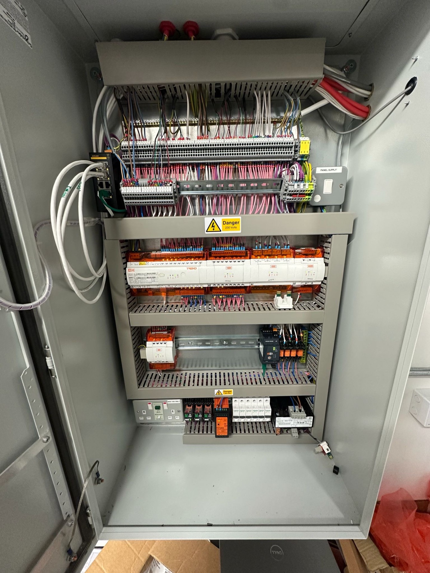 New Trend BMS control panel upgrade in London commercial plant room with IO modules, relays and labelled terminals